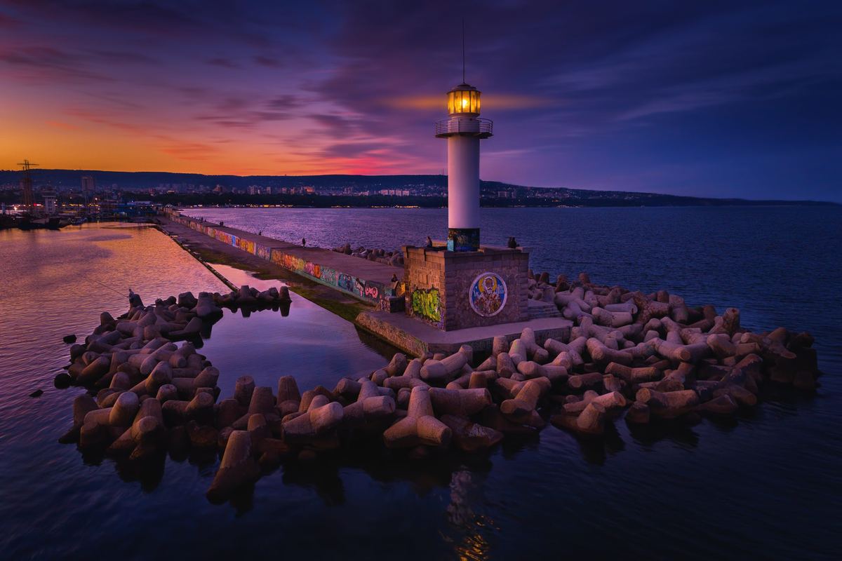 Lighthouse on the pier at sunset