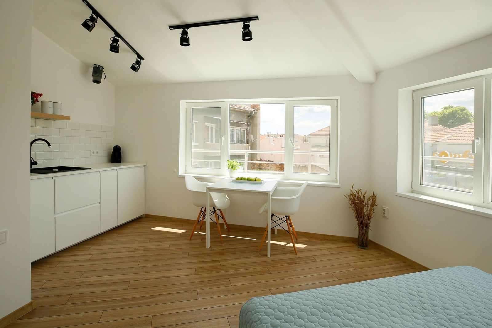 Studio with kitchenette, dining table and large windows