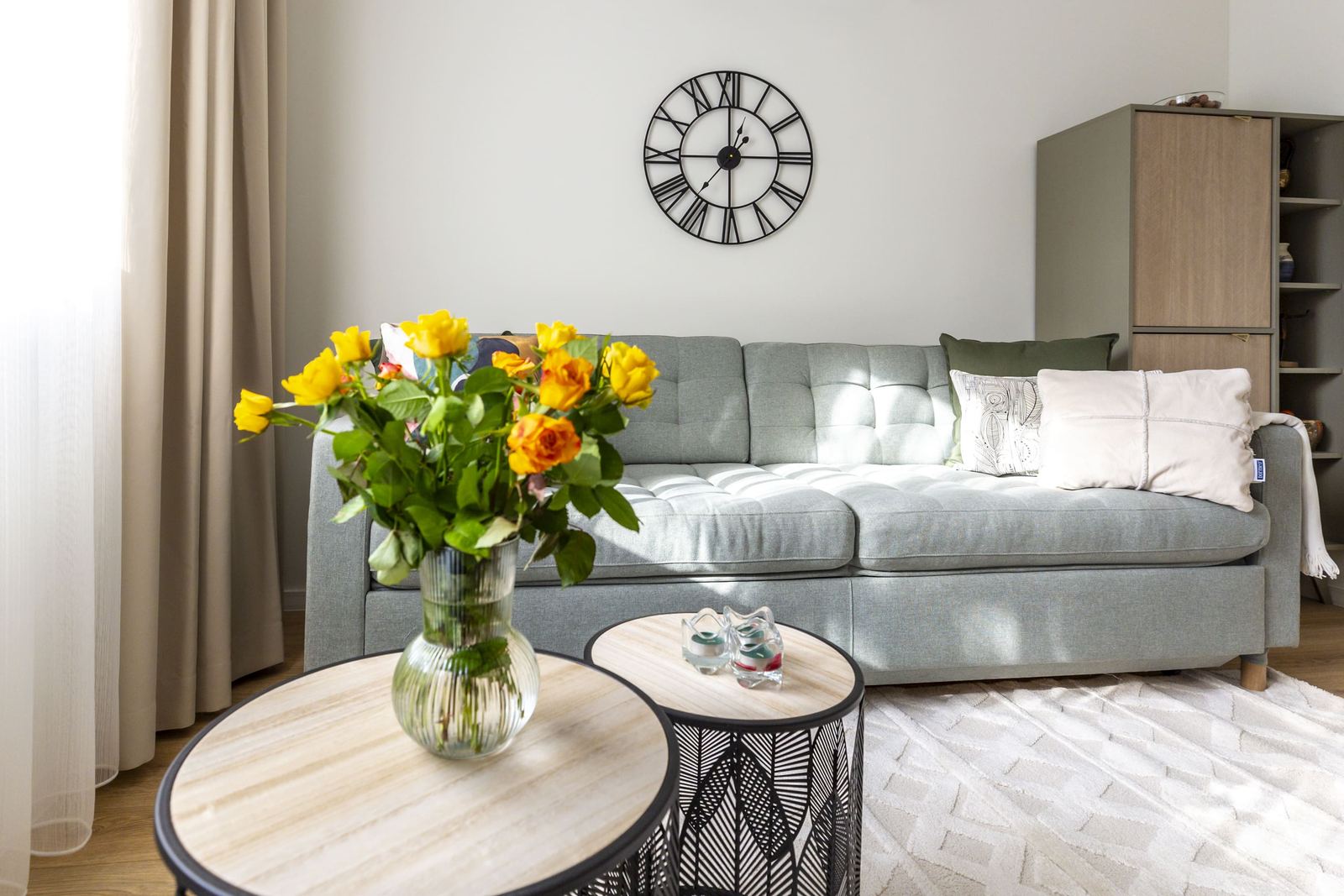 Grey sofa with yellow roses on the coffee table
