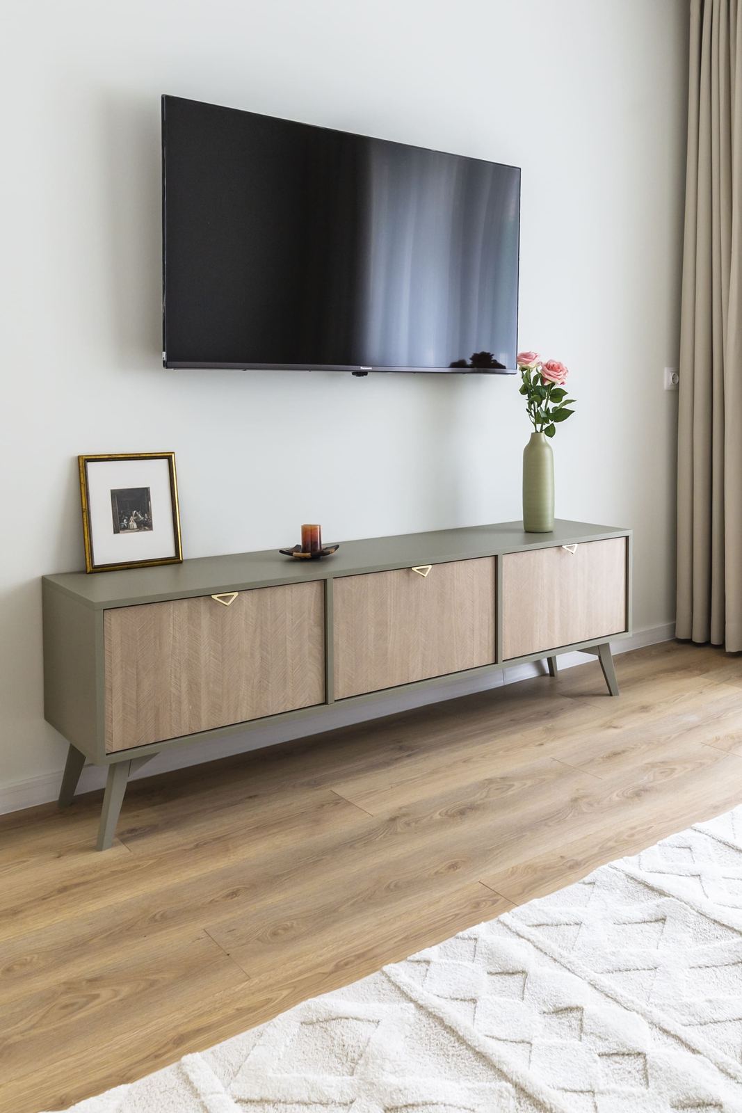 TV console with roses and a framed picture