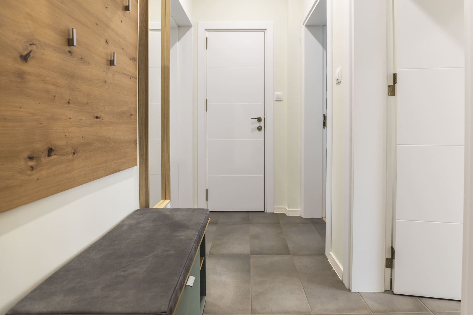 Hallway with a bench and a wooden coat panel