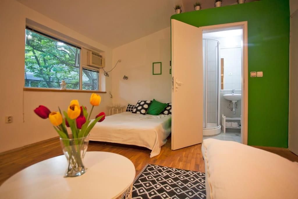 Bed and tulips with the bathroom door open