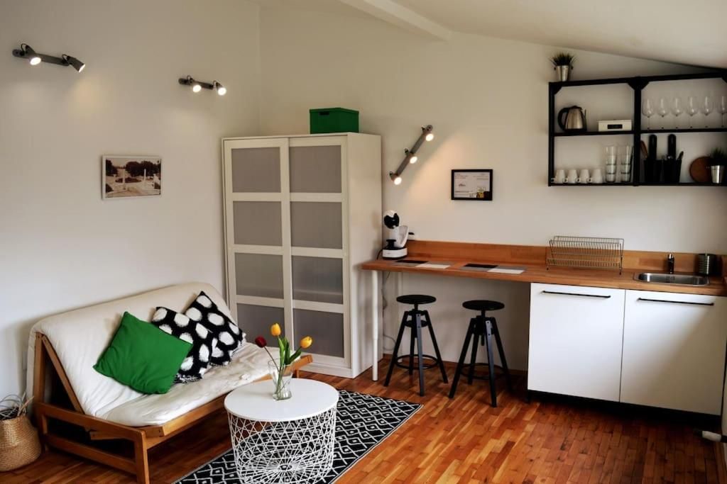 Living area with futon sofa, wardrobe and kitchenette