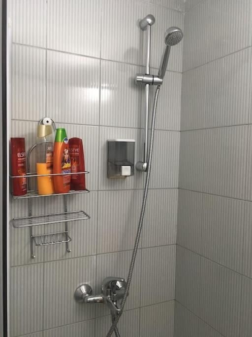 Shower with shelf and wall-mounted soap dispenser